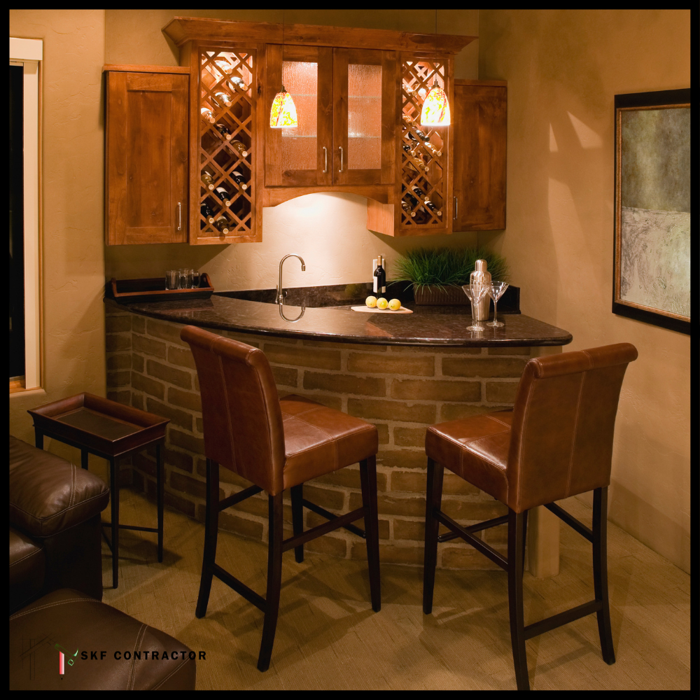 Curved stone bar unit with dark granite top, tan leather stools, diamond wine rack, and pendant lights.
