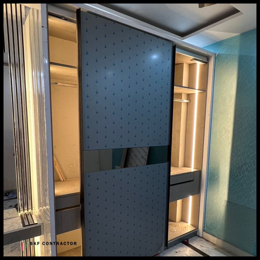 Sliding door wardrobe with blue patterned shutter, mirror panel and internal LED lighting.