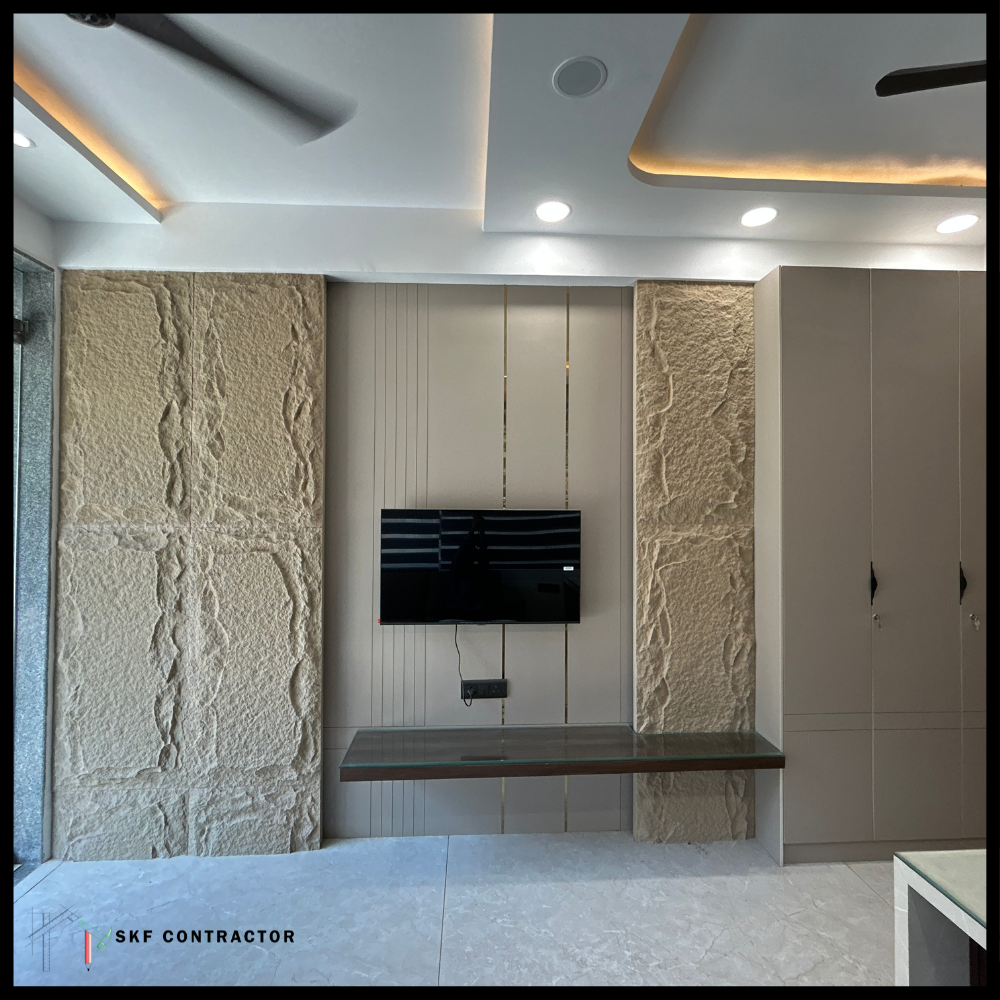 TV wall with textured stone panels, vertical strips, floating shelf and false ceiling
