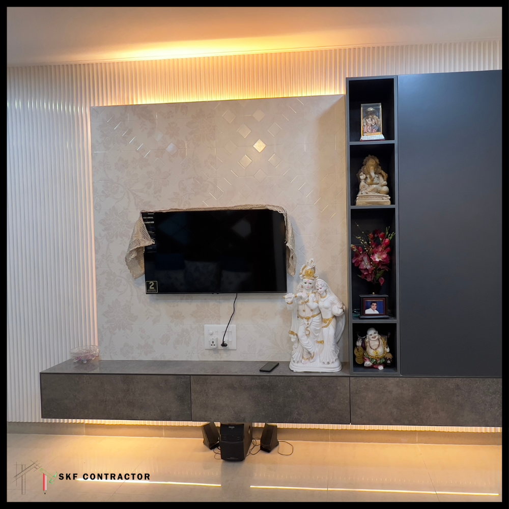 TV unit with fluted wall panel, LED cove lighting, marble backdrop and dark grey display shelves.