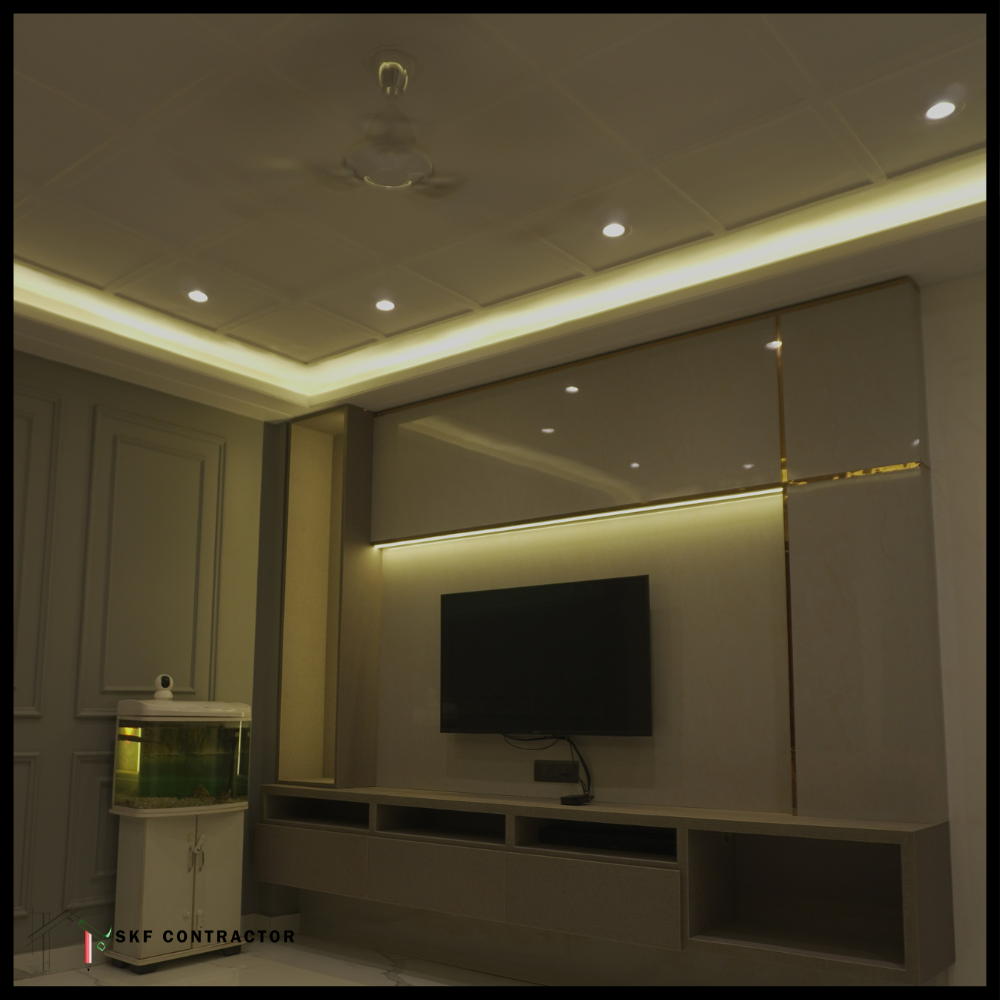 TV wall panel with gold trim, LED backlight, open storage unit and false ceiling.