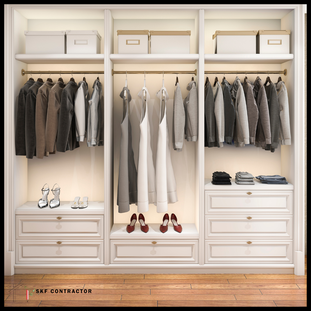 Classic white open wardrobe with hanging rods, gold accents, drawers and warm internal lighting.