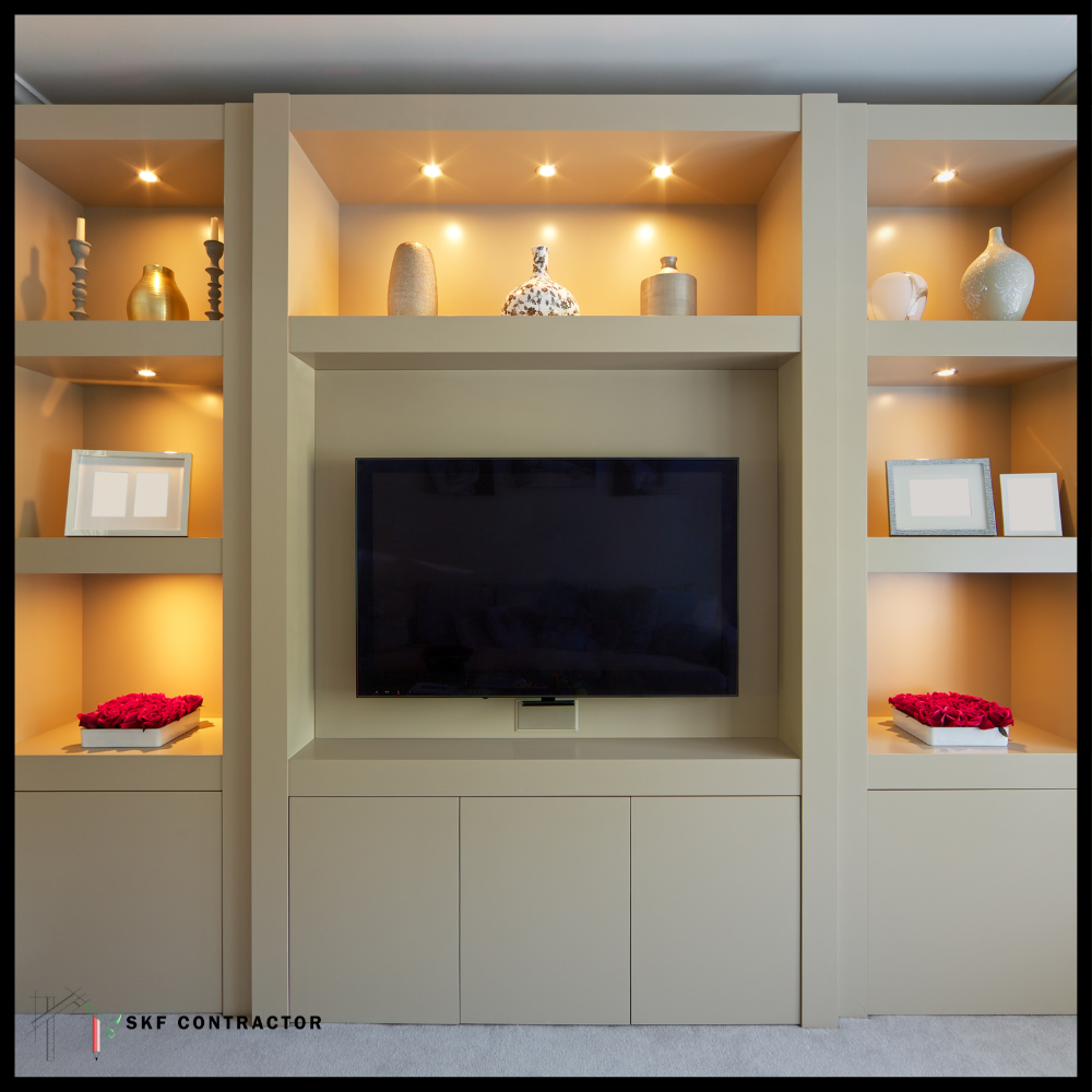 Full-wall TV unit with lit display shelves, bottom cabinets and decorative niches in beige finish.