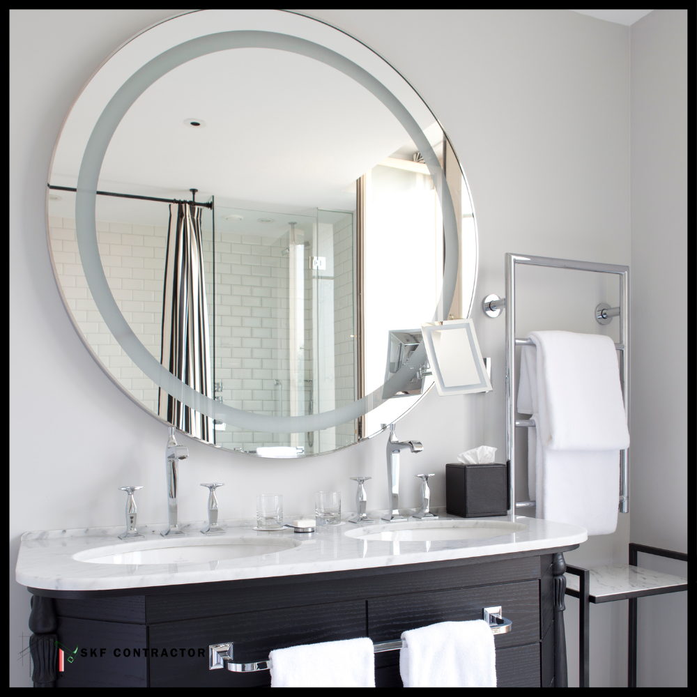 Luxury double vanity with dark wood cabinet, marble countertop, chrome faucets, large round backlit mirror.