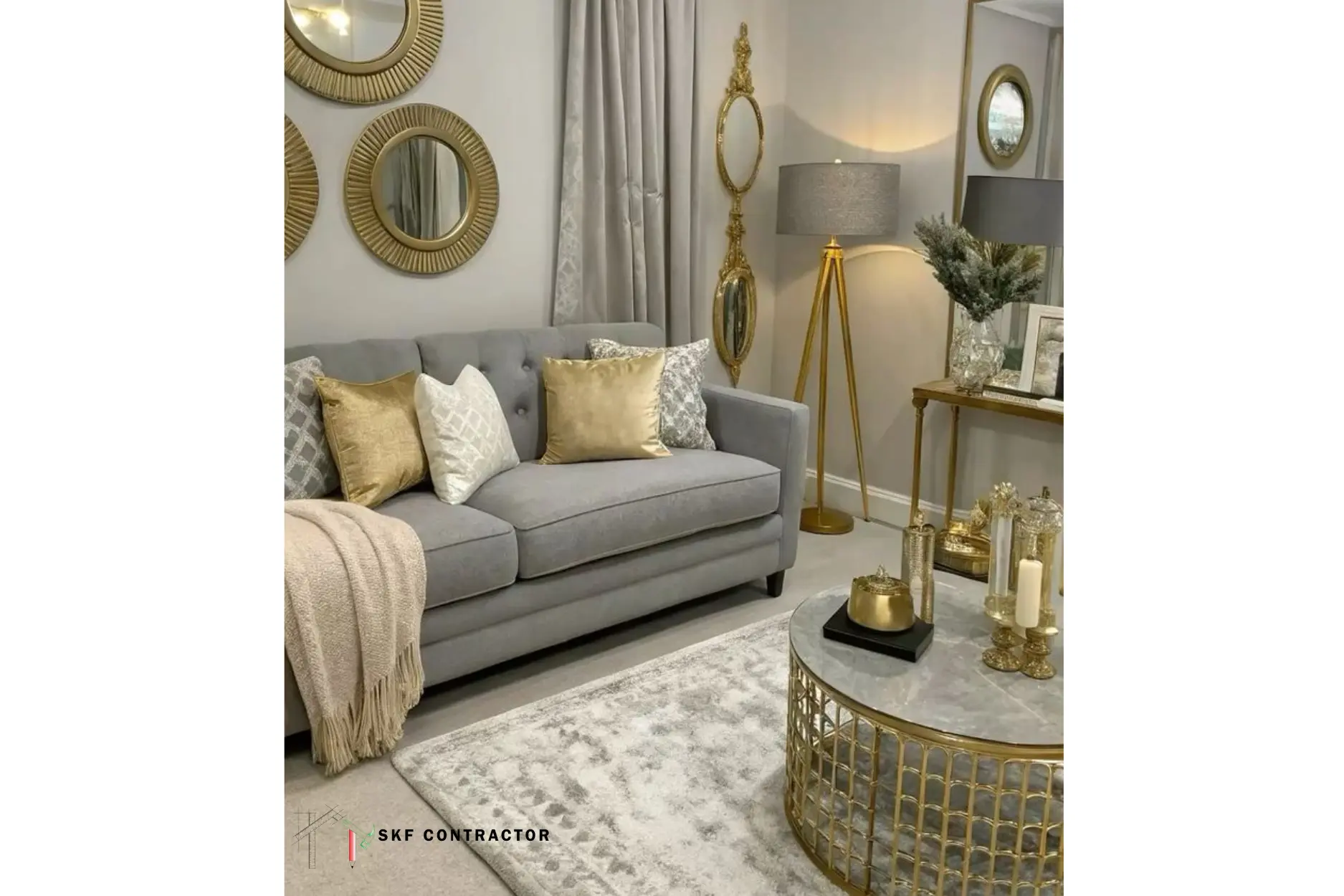 Grey and gold living room sofa with round gold mirrors and marble coffee table