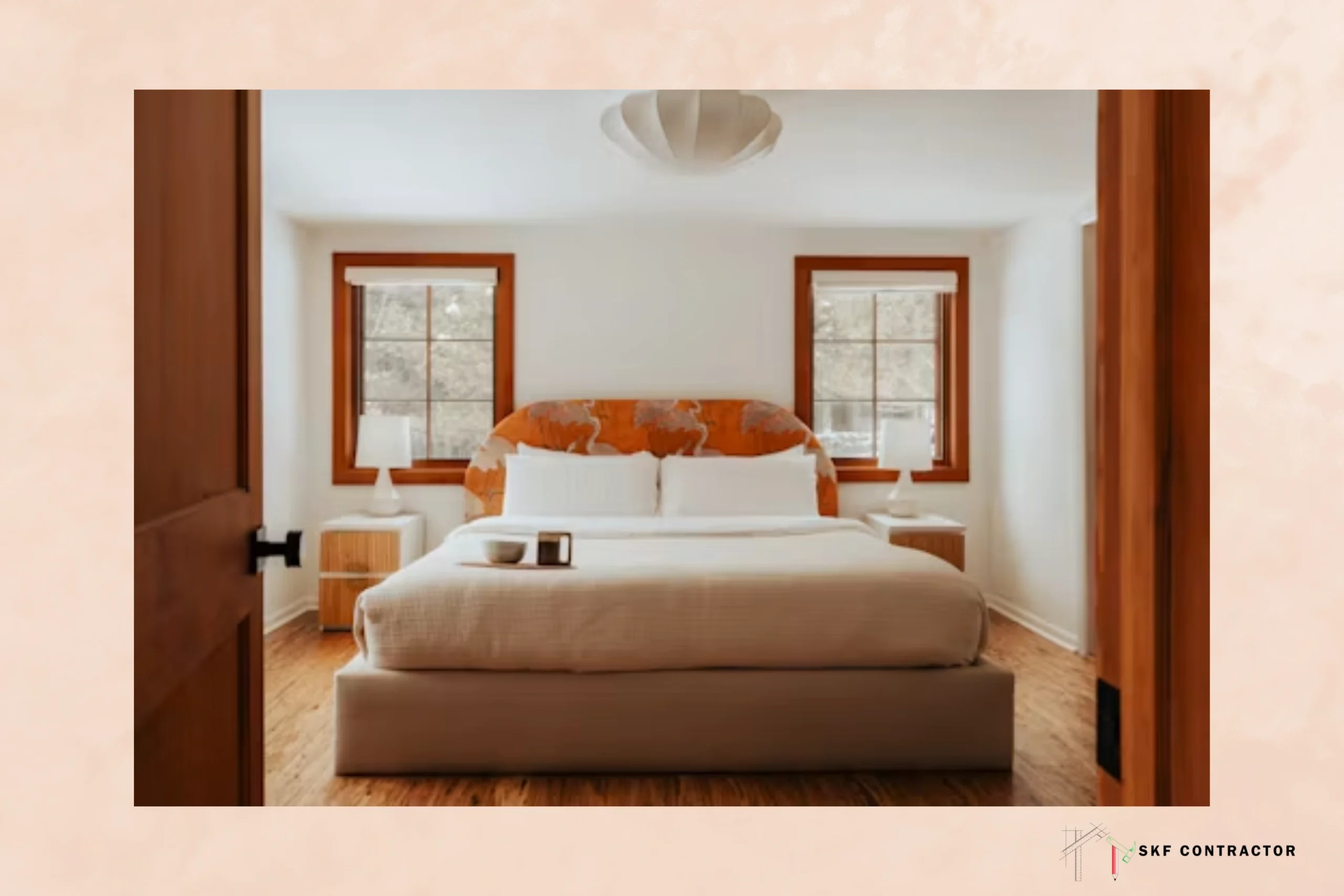 Bright, inviting bedroom with a neatly made bed, orange accent pillows, wood-framed windows, and warm natural light creating a cozy mood.