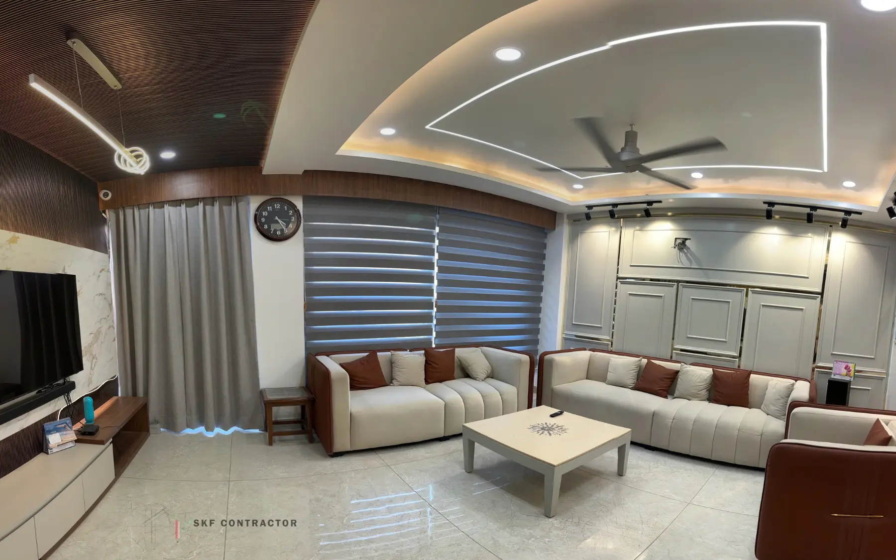 Living room with wooden slat wall and marble TV panel, designed by SKF Contractor in Delhi